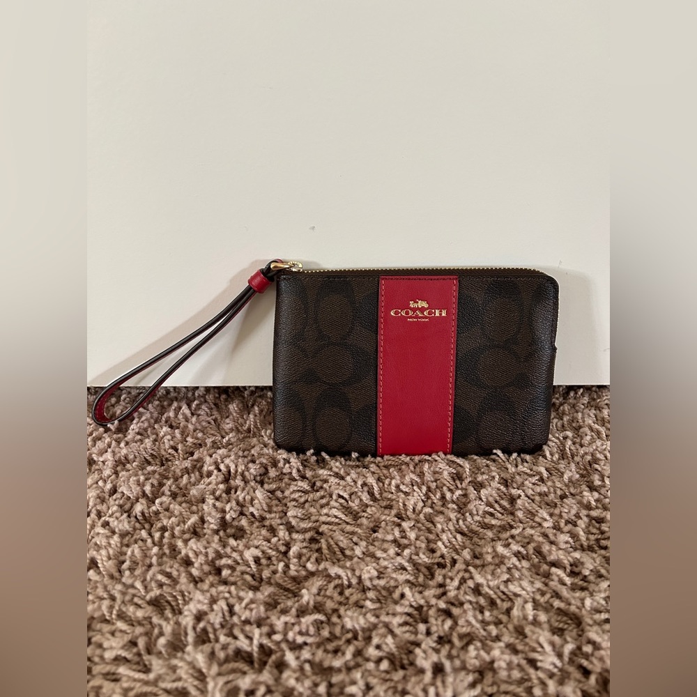 coach wristlet with red detailing